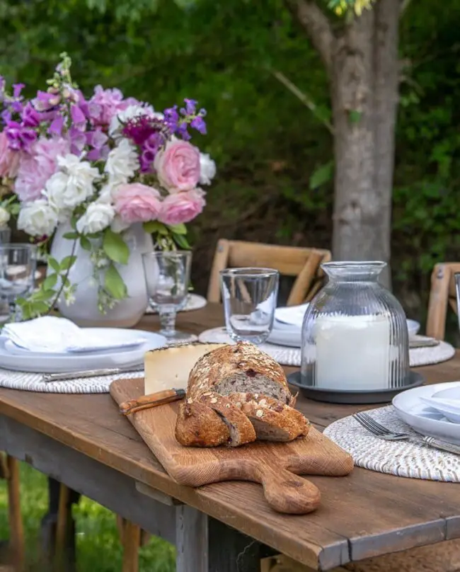 Charming Garden Table Featuring Bread and Flowers