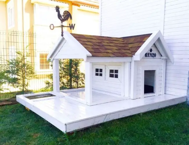 Charming White Dog House with Weather Vane