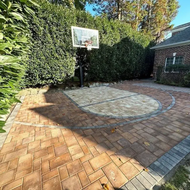 Elegant Brick Court Set Against a Hedge Backdrop