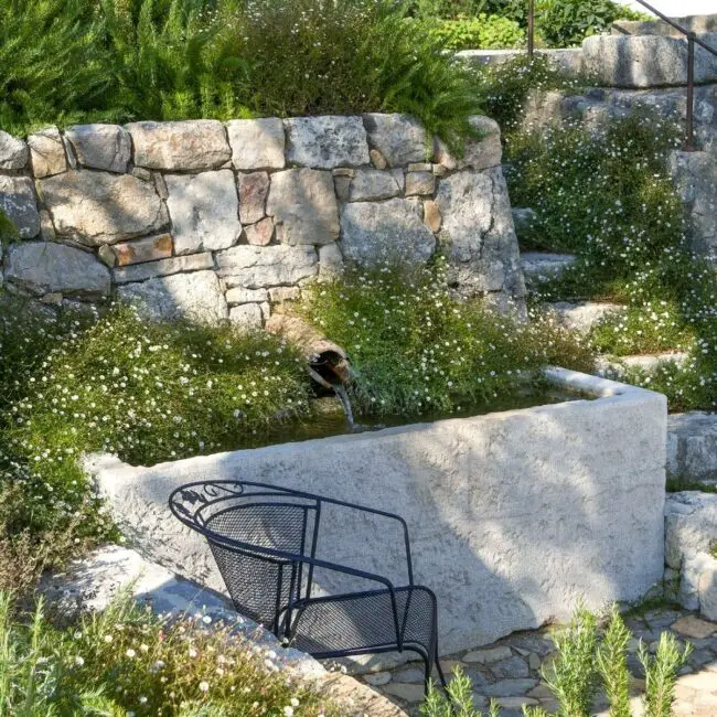 Rustic Stone Fountain Surrounded by Wildflowers